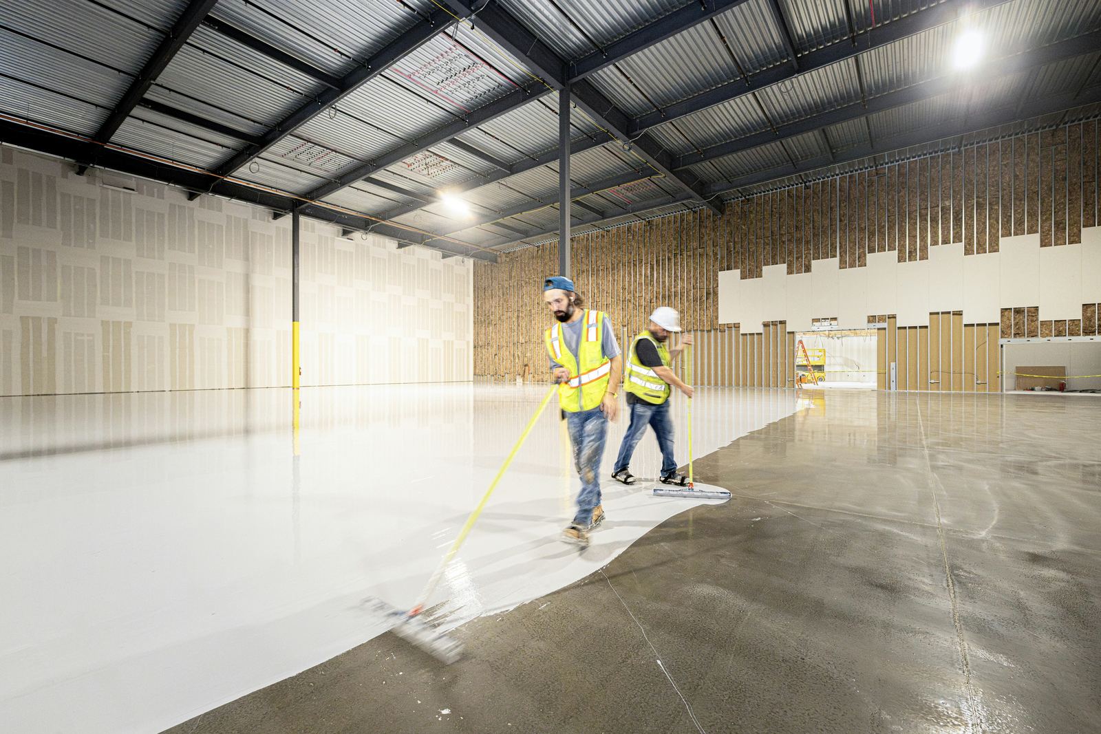 Image of a professional cleaner using eco-friendly cleaning products on a commercial floor