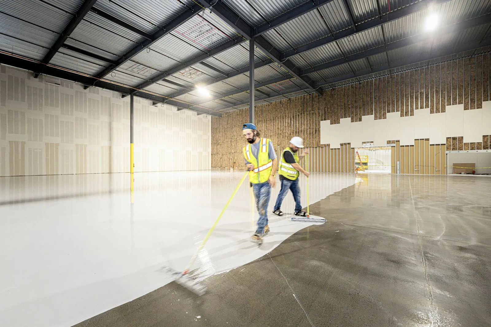 Image of a professional cleaner using eco-friendly cleaning products on a commercial floor